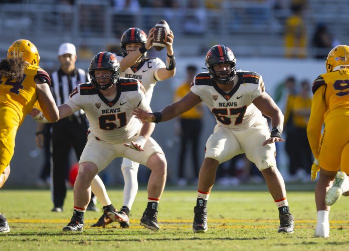 Oregon State Beavers offensive lineman Tanner Miller (61) and Joshua Gray (67) against the Arizona State Sun Devils at Sun Devil Stadium.