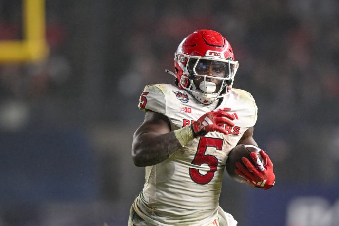 Rutgers Scarlet Knights running back Kyle Monangai (5) runs with the ball against the Miami Hurricanes during the fourth quarter at Yankee Stadium. Mandatory Credit: Mark Smith-USA TODAY Sports