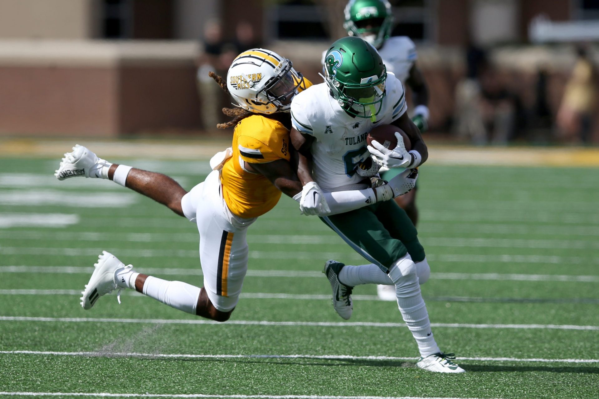 Tulane Green Wave wide receiver Lawrence Keys III (6) is tackled by Southern Miss Golden Eagles safety Dylan Lawrence (6) in the first half at M.M. Roberts Stadium.