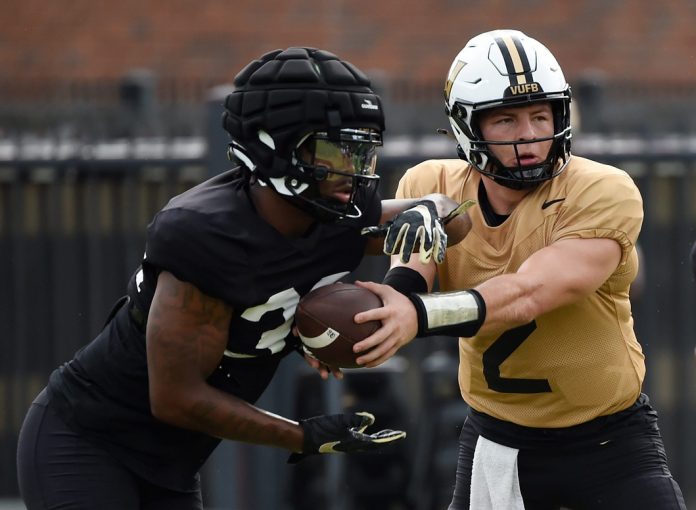 Vanderbilt quarterback Diego Pavia (2) hands the ball of to running back Jamoni Jones (33) during an NCAA college football practice Friday, Aug. 2, 2024, in Nashville, Tenn.