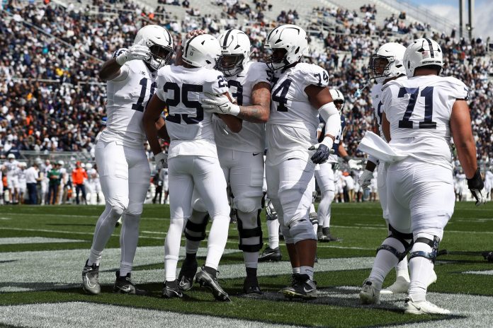 Penn State Nittany Lions running back Quinton Martin Jr (25) celebrates with teammates after scoring a touchdown during the second quarter of the Blue White spring game at Beaver Stadium. The White team defeated the Blue team 27-0. Mandatory Credit: Matthew O'Haren-USA TODAY Sports