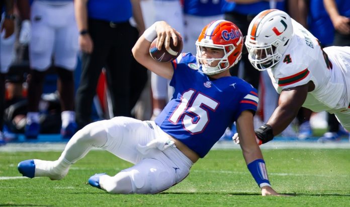 Florida Gators quarterback Graham Mertz (15) slides during a play while being pursued by Miami Hurricanes defensive lineman Rueben Bain Jr. (4) uring the season opener at Ben Hill Griffin Stadium in Gainesville, FL on Saturday, August 31, 2024 against the University of Miami Hurricanes in the first half. [Doug Engle/Gainesville Sun]