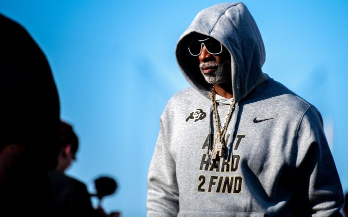 CU football head coach Deion Sanders, or Coach Prime, watches his team warm up before the game against CSU in the Rocky Mountain Showdown at Canvas Stadium.