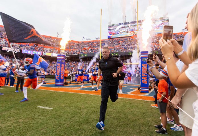 Florida Gators head coach Billy Napier runs onto the field before the start of the game at Ben Hill Griffin Stadium in Gainesville, FL on Saturday, September 7, 2024 against the Samford Bulldogs. The Gators won 45-7. [Doug Engle/Gainesville Sun]