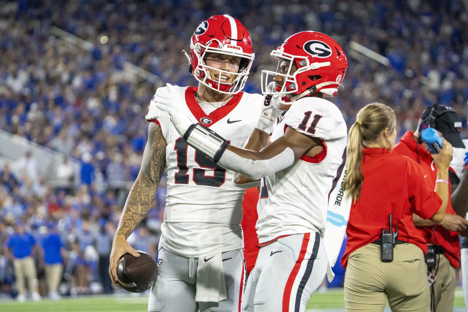 Georgia Bulldogs quarterback Carson Beck (15) and wide receiver Arian Smith (11) talk during a time out during the second quarter against the Kentucky Wildcats at Kroger Field.