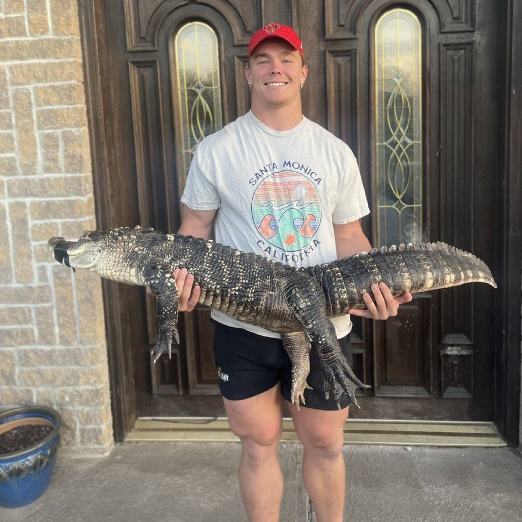 Carson Steele shows off his pet alligator, Crocky-J