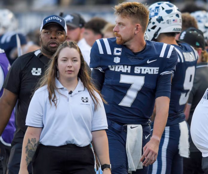 Utah State quarterback Spencer Petras (7) walks to the locker room after getting injured in the first half of an NCAA college football game against Robert Morris.