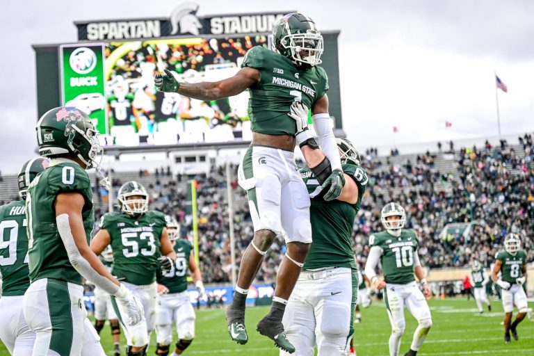 Michigan State's Jayden Reed, center, is hoisted by J.D. Duplain after Reed's touchdown catch against Rutgers during the third quarter on Saturday, Nov. 12, 2022, in East Lansing.

221112 Msu Rutgers Fb 151a