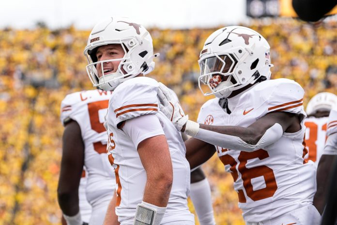 Texas quarterback Quinn Ewers (3) celebrates a touchdown against Michigan during the first half at Michigan Stadium in Ann Arbor.