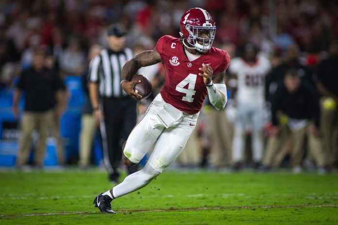 Alabama Crimson Tide quarterback Jalen Milroe (4) runs against the Georgia Bulldogs during the first quarter at Bryant-Denny Stadium.