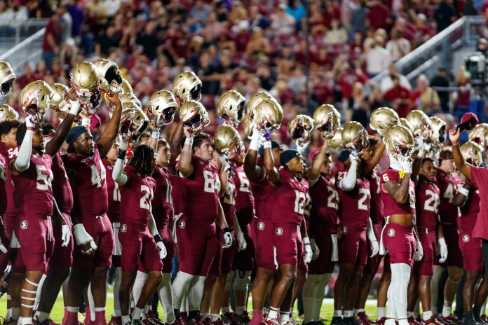 Florida State Seminoles players raise their helmets before the game against the North Alabama Lions at Doak S. Campbell Stadium.