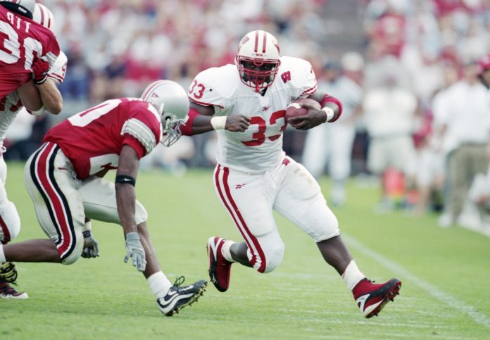 Oct 2, 1999; Columbus, OH, USA; Wisconsin Badgers running back Ron Dayne (33) runs with the ball against the Ohio State Buckeyes at Ohio Stadium. The Badgers beat the Buckeyes 42-17. Mandatory Credit: Matthew Emmons-USA TODAY Sports