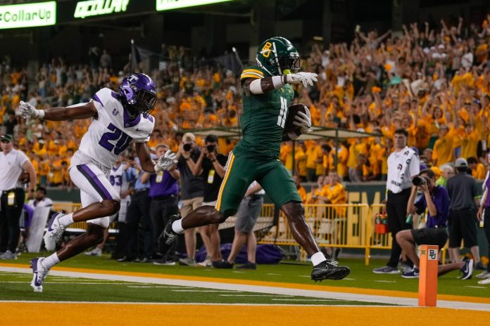 Baylor Bears wide receiver Ketron Jackson Jr. (11) scores a touchdown against Tarleton State Texans defensive back Greg Eggleston JR. (20) during the second half at McLane Stadium. Mandatory Credit: Chris Jones-USA TODAY Sports