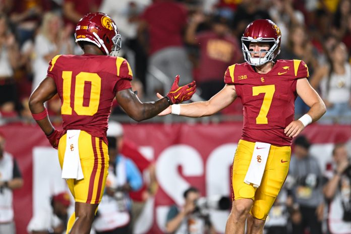 USC Trojans quarterback Miller Moss (7) celebrates with USC Trojans wide receiver Kyron Hudson (10) after scoring a touchdown against Utah State Aggies during the first quarter at United Airlines Field at Los Angeles Memorial Coliseum. Mandatory Credit: Jonathan Hui-Imagn Images