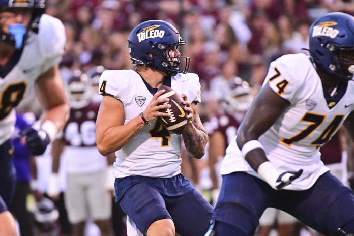 Sep 14, 2024; Starkville, Mississippi, USA; Toledo Rockets quarterback Tucker Gleason (4) looks to pass against the Mississippi State Bulldogs during the first quarter at Davis Wade Stadium at Scott Field. Mandatory Credit: Matt Bush-Imagn Images