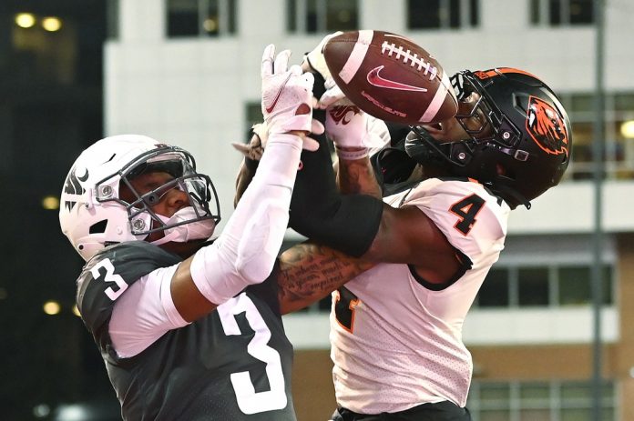 Oregon State Beavers defensive back Jaden Robinson (4) breaks up a pass intended for Washington State Cougars wide receiver Josh Kelly (3) in the second half at Gesa Field at Martin Stadium. Washington State won 38-35. Mandatory Credit: James Snook-USA TODAY Sports