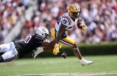 LSU freshman running back Caden Durham (29) dodged a tackle from a South Carolina defender during an SEC football game at Williams-Brice Stadium Sept. 14, 2024.