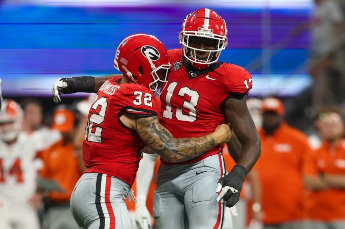 Georgia Bulldogs defensive lineman Mykel Williams (13) celebrates after a tackle with linebacker Chaz Chambliss (32) against the Clemson Tigers in the third quarter at Mercedes-Benz Stadium. Mandatory Credit: Brett Davis-USA TODAY Sports