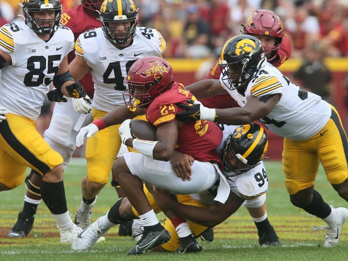 Iowa State Cyclones' running back Abu Sama (24) gets tackle by Iowa Hawkeyes' defensive line Yahya Black (94) and linebacker Jay Higgins (34) after making a first down during the third quarter of the cy-Hawk football game at the Jack Trice Stadium on Saturday, Sept. 9, 2023, in Ames, Iowa.