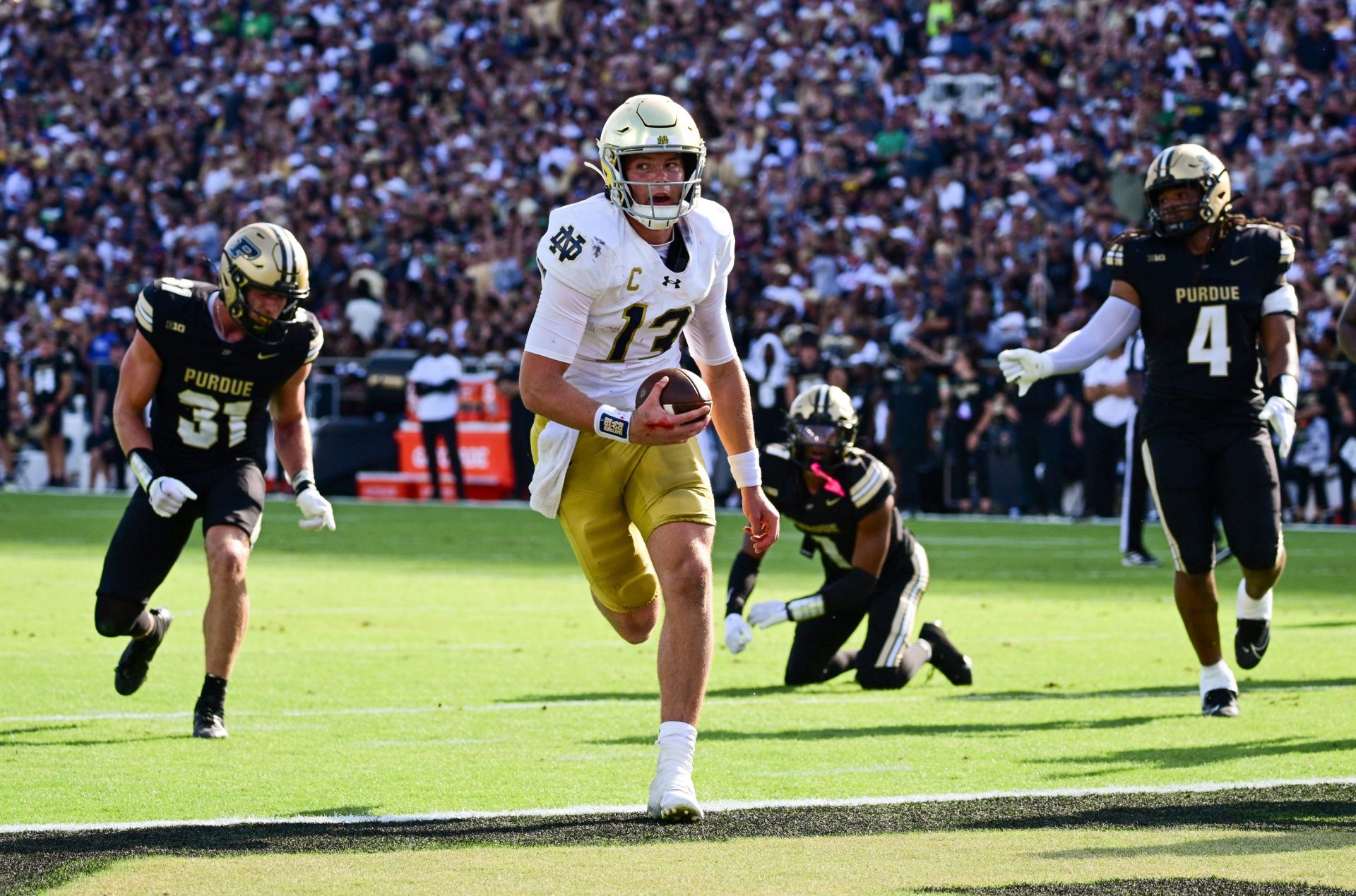 Notre Dame Fighting Irish quarterback Riley Leonard (13) runs the ball in for a touchdown against the Purdue Boilermakers during the second quarter at Ross-Ade Stadium.