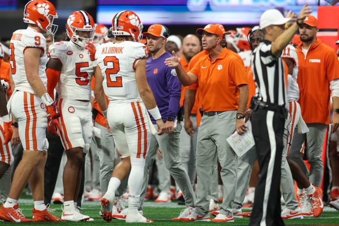 Clemson Tigers quarterback Cade Klubnik (2) talks to head coach Dabo Swinney against the Georgia Bulldogs in the second quarter at Mercedes-Benz Stadium. How do they fare in our NC State vs. Clemson prediction?