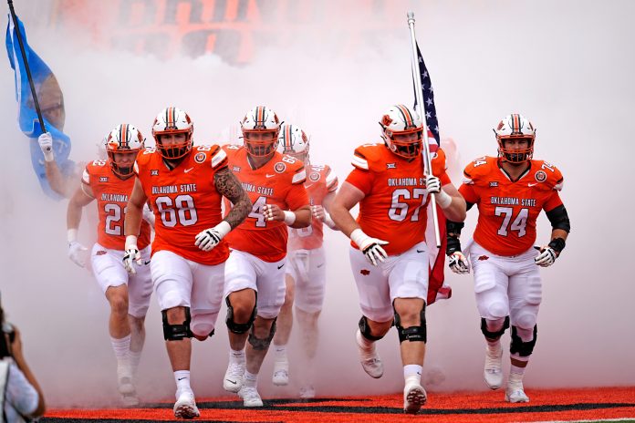 Oklahoma State runs on to the field before the college football game between the Oklahoma State Cowboys and South Dakota State Jackrabbits at Boone Pickens Stadium in Stillwater, Okla., Saturday, Aug., 31, 2024. © SARAH PHIPPS/THE OKLAHOMAN / USA TODAY NETWORK