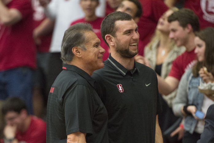 Stanford Cardinal former quarterbacks Jim Plunkett (left) and Andrew Luck (right) pose for a photo during the second half against the Arizona Wildcats at Maples Pavilion. The Wildcats defeated the Cardinal 71-57.