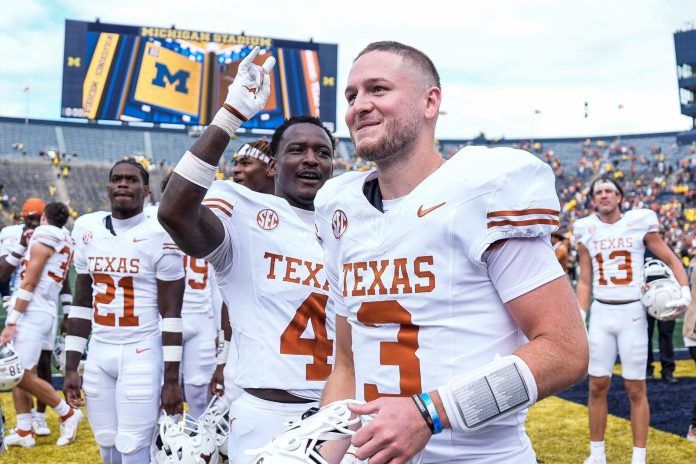 Texas quarterback Quinn Ewers (3) and teammates celebrate 31-12 win over Michigan at Michigan Stadium in Ann Arbor on Saturday, September 7, 2024.