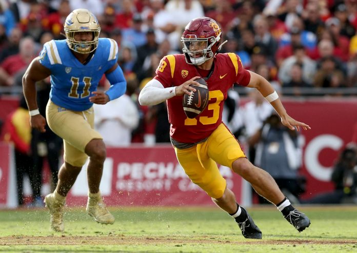 USC Trojans quarterback Caleb Williams (13) scrambles during the third quarter against the UCLA Bruins at United Airlines Field at Los Angeles Memorial Coliseum. Mandatory Credit: Jason Parkhurst-USA TODAY Sports