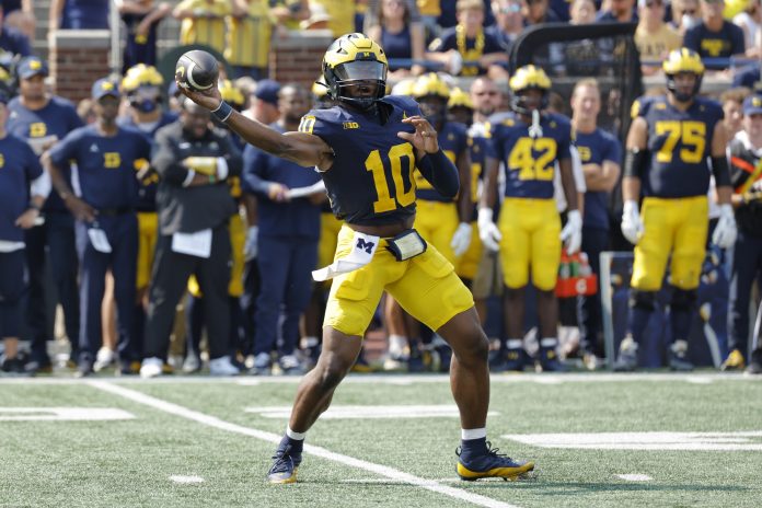 Sep 14, 2024; Ann Arbor, Michigan, USA; Michigan Wolverines quarterback Alex Orji (10) passes second half against the Arkansas State Red Wolves at Michigan Stadium. Mandatory Credit: Rick Osentoski-Imagn Images