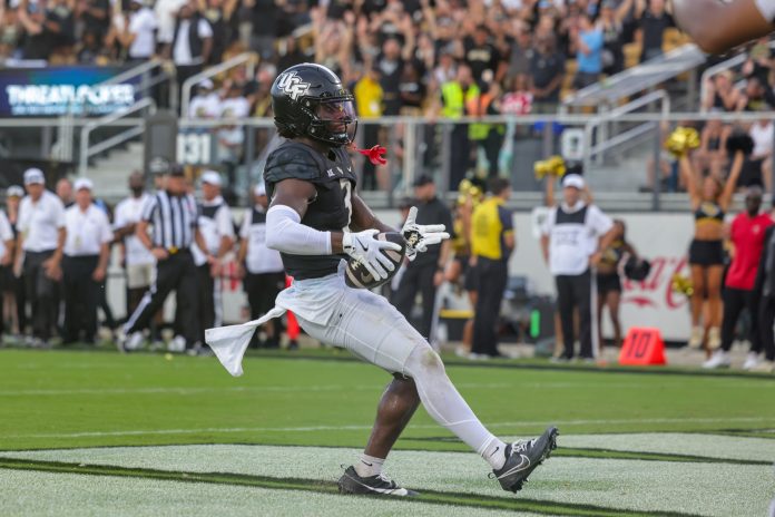 UCF Knights wide receiver Xavier Townsend (3) celebrates after scoring during the second half against the Colorado Buffaloes at FBC Mortgage Stadium.