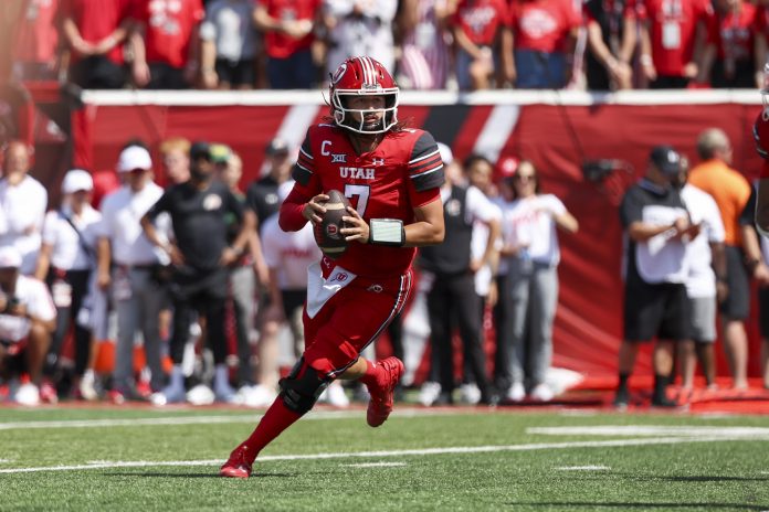 Utah Utes quarterback Cameron Rising (7) drops back to throw the ball against the Baylor Bears during the first quarter at Rice-Eccles Stadium.