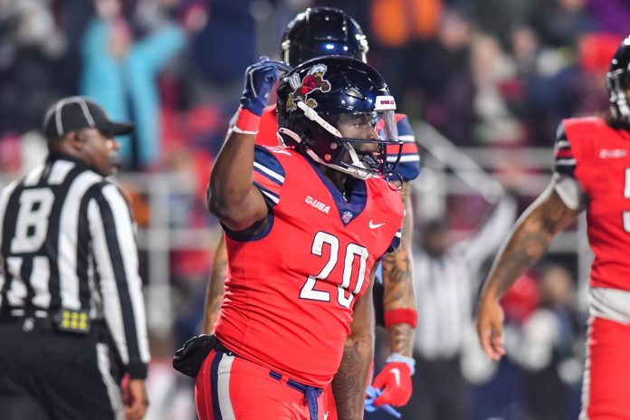 Liberty Flames running back Quinton Cooley (20) celebrates a touchdown against the New Mexico State Aggies at Williams Stadium.