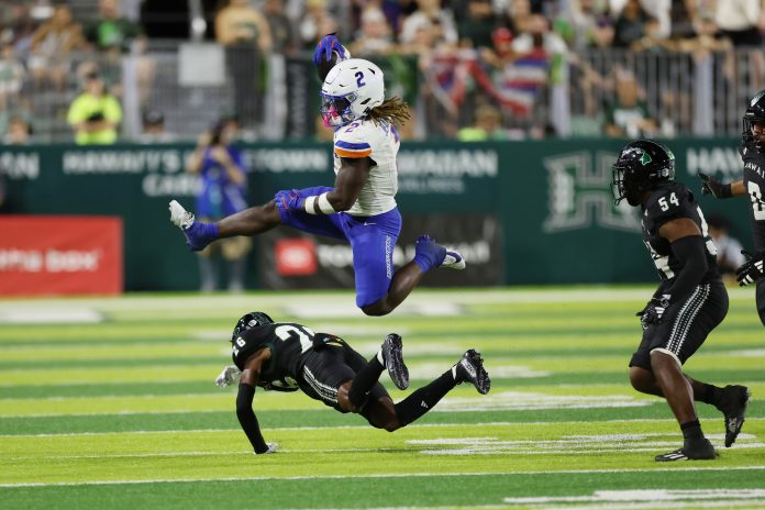 Boise State Broncos running back Ashton Jeanty (2) leaps over Hawaii Rainbow Warriors defensive back Deliyon Freeman (26) during the second quarter at Clarence T.C. Ching Athletics Complex. The play was called back due to a Broncos foul.