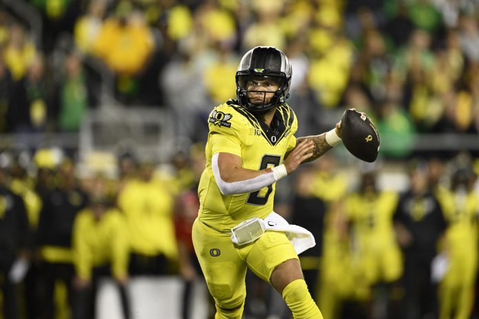 Oregon Ducks quarterback Dillon Gabriel (8) throws a touchdown pass during the second half against the Michigan State Spartans at Autzen Stadium.