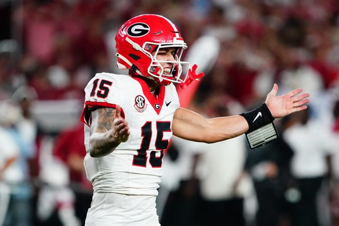 Georgia Bulldogs quarterback Carson Beck (15) reacts after throwing a pass for a touchdown against the Alabama Crimson Tide during the fourth quarter at Bryant-Denny Stadium.