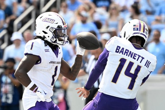 James Madison Dukes wide receiver Cam Ross (1) celebrates with quarterback Alonza Barnett III (14) after scoring a touchdown in the second quarter at Kenan Memorial Stadium.