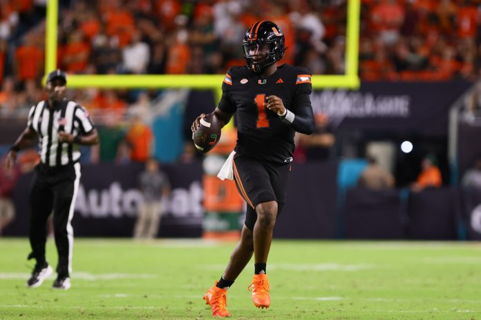 Miami Hurricanes quarterback Cam Ward (1) runs with the football against the Florida State Seminoles during the second quarter at Hard Rock Stadium.