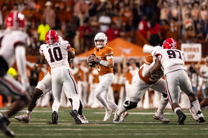 Texas Longhorns quarterback Quinn Ewers (3) drops back to pass against the Georgia Bulldogs during the first half at Darrell K Royal-Texas Memorial Stadium.