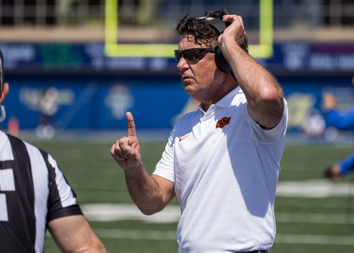 Oklahoma State Cowboys head coach Mike Gundy talks to an official during the second quarter against the Tulsa Golden Hurricane at Skelly Field at H.A. Chapman Stadium.