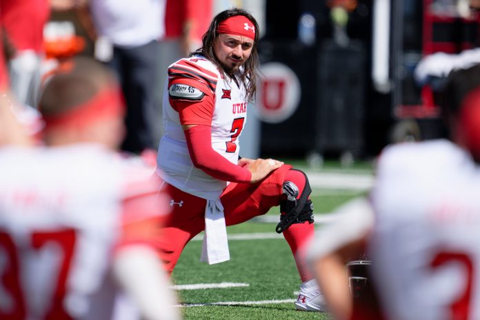 Utah Utes quarterback Cameron Rising (7) warms up before a game against the Utah State Aggies at Merlin Olsen Field at Maverik Stadium.