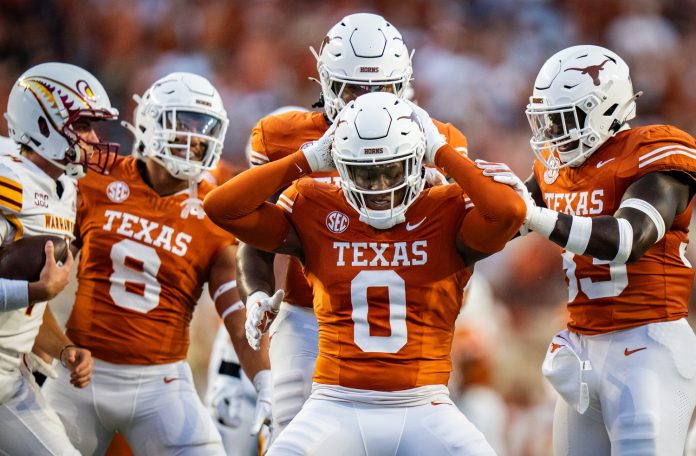 Texas Longhorns linebacker Anthony Hill Jr. (0) celebrates sacking Louisiana Monroe Warhawks quarterback General Booty (14) in the first half of the Texas Longhorns' game against the ULM Warhawks at Darrell K Royal Texas Memorial Stadium.