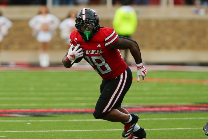 Texas Tech Red Raiders running back Tahj Brooks (28) runs the ball against the Baylor Bears in the first half at Jones AT&T Stadium and Cody Campbell Field.