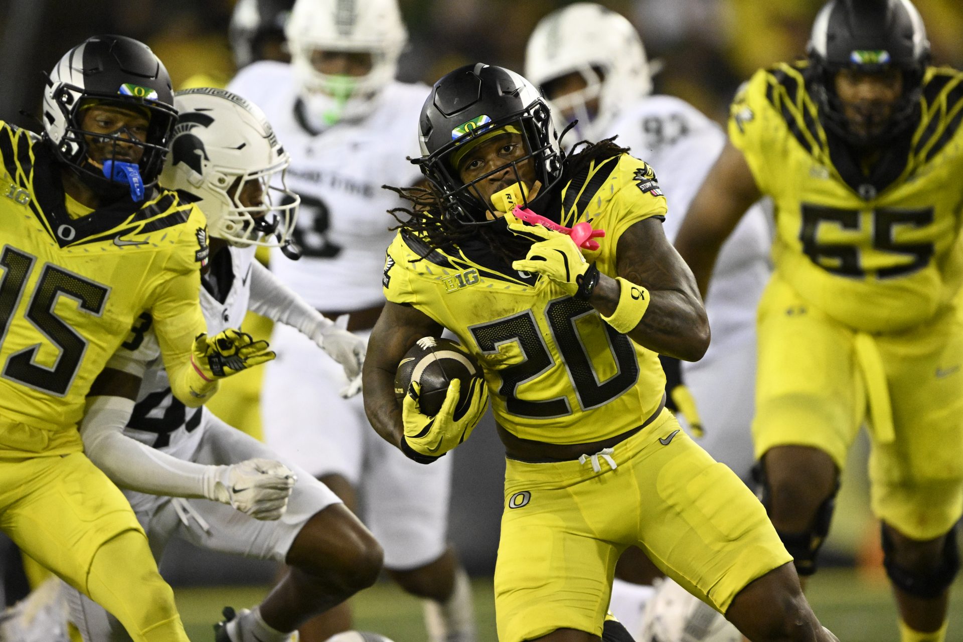 Oregon Ducks running back Jordan James (20) breaks away from Michigan State Spartans defenders during the first half at Autzen Stadium.