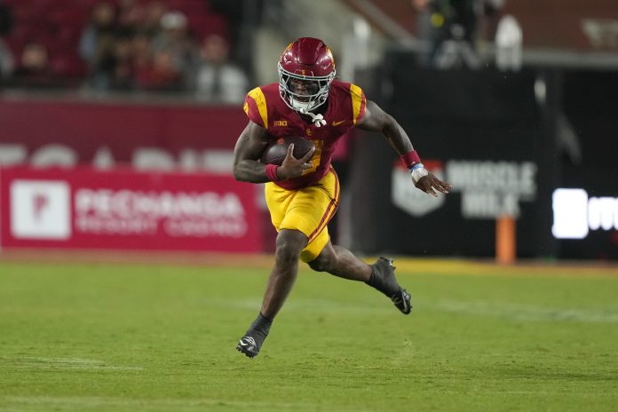 Southern California Trojans running back Woody Marks (4) carries the ball against the Rutgers Scarlet Knights in the second half at United Airlines Field at Los Angeles Memorial Coliseum.