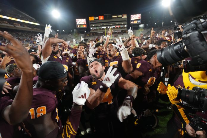 Arizona State running back Cam Skattebo (4) celebrates with his teammates after their 35-31 win against the Kansas Jayhawks at Mountain America Stadium.