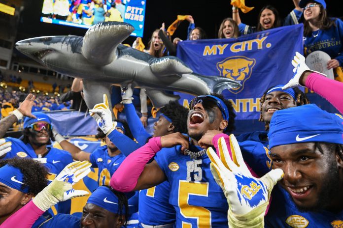 Pittsburgh Panthers defensive back Phillip O'Brien Jr. (5) celebrates with his teammates after beating the Syracuse Orange at Acrisure Stadium.