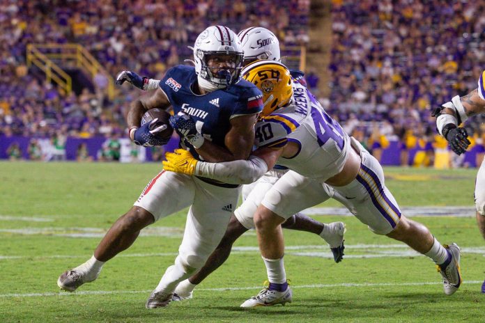 South Alabama Jaguars running back Fluff Bothwell (24) is tackled by LSU Tigers linebacker Whit Weeks (40) during the second half at Tiger Stadium.