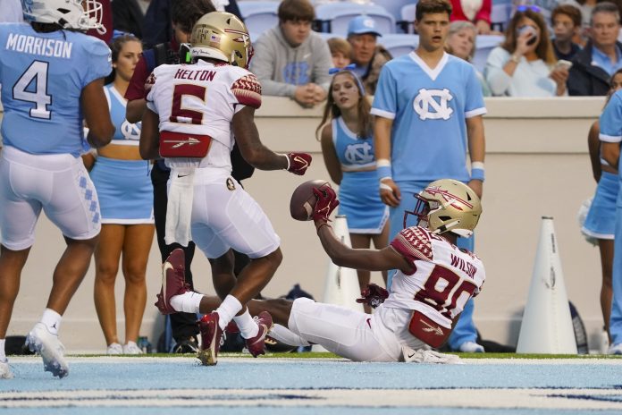 Florida State Seminoles wide receiver Ontaria Wilson (80) celebrates his second half touchdown catch with wide receiver Keyshawn Helton (6) against the North Carolina Tar Heels at Kenan Memorial Stadium.