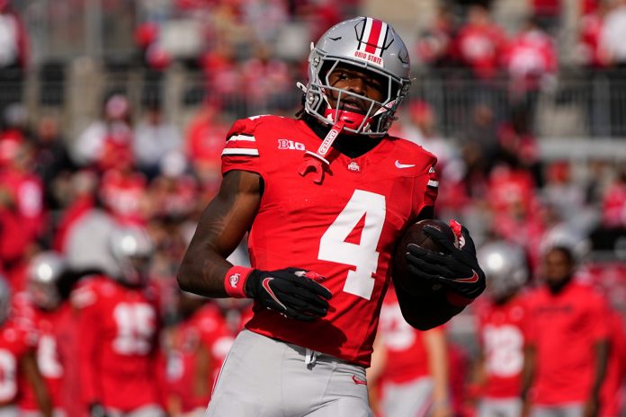 Ohio State Buckeyes wide receiver Jeremiah Smith (4) warms up prior to the NCAA football game against the Nebraska Cornhuskers at Ohio Stadium in Columbus on Saturday, Oct. 26, 2024.